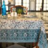 Nappe Kerala Dream en coton, imprimée à la main avec des motifs floraux en bleu et vert, posée sur une table élégamment dressée.