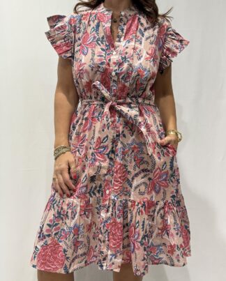 Robe Sitara Rose Pale -Femme portant une robe courte à manches volantées et imprimé floral, avec ceinture à la taille et boutons sur le devant.