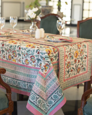 Nappe Dalia rectangulaire, motifs floraux colorés sur fond clair, finitions roses et vertes, décor de table raffiné. Taille : 150 x 230 et 180 x 340