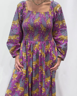 Robe Léora Violette, une robe longue smockée. Fluide et 100 % coton. Elle est de couleur violette avec des imprimés de léopard.