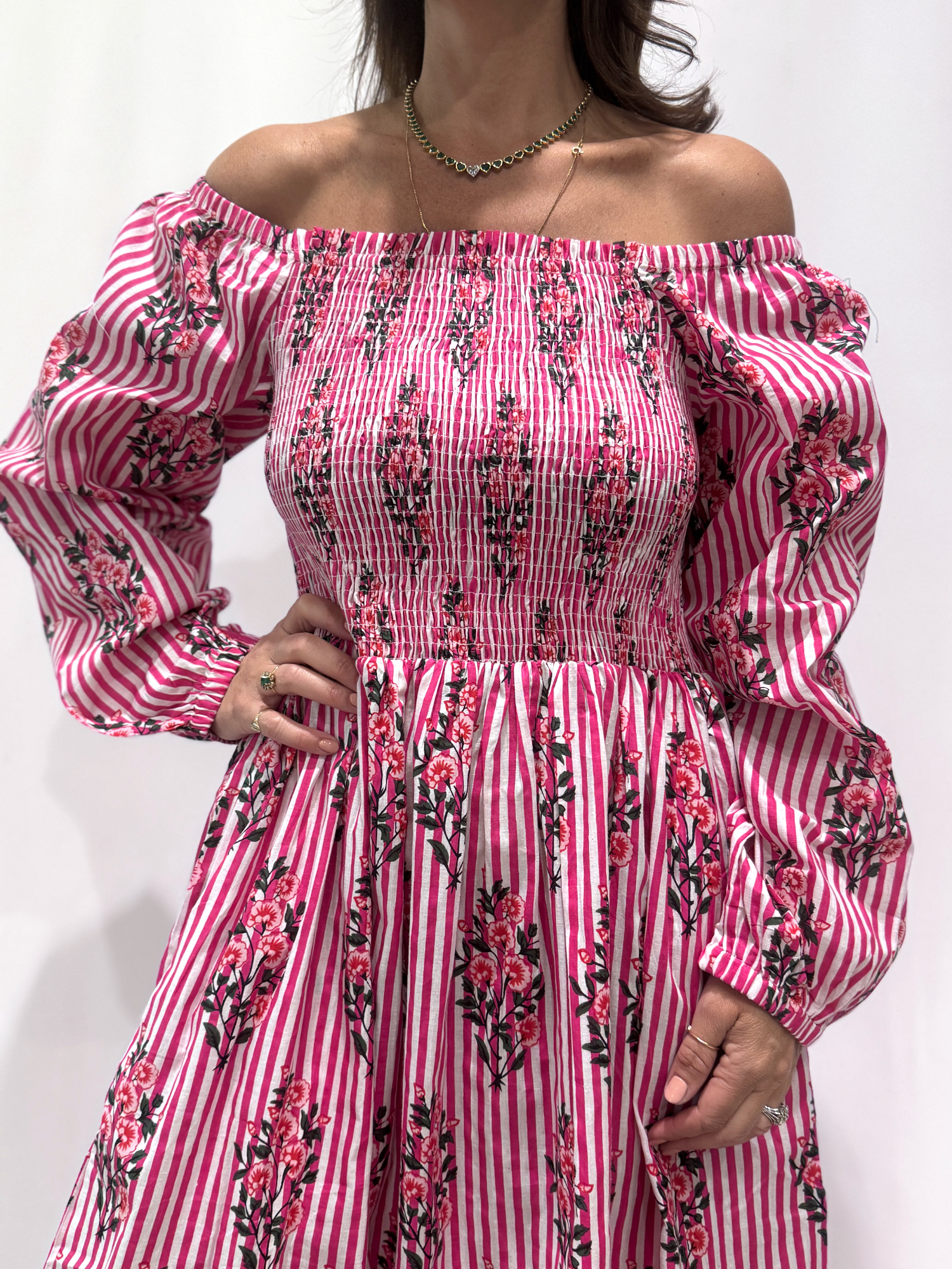 Robe Naya Rose Rayée, une robe longue smockée. Fluide et 100 % coton. Elle est rayée avec des imprimés de fleurs.